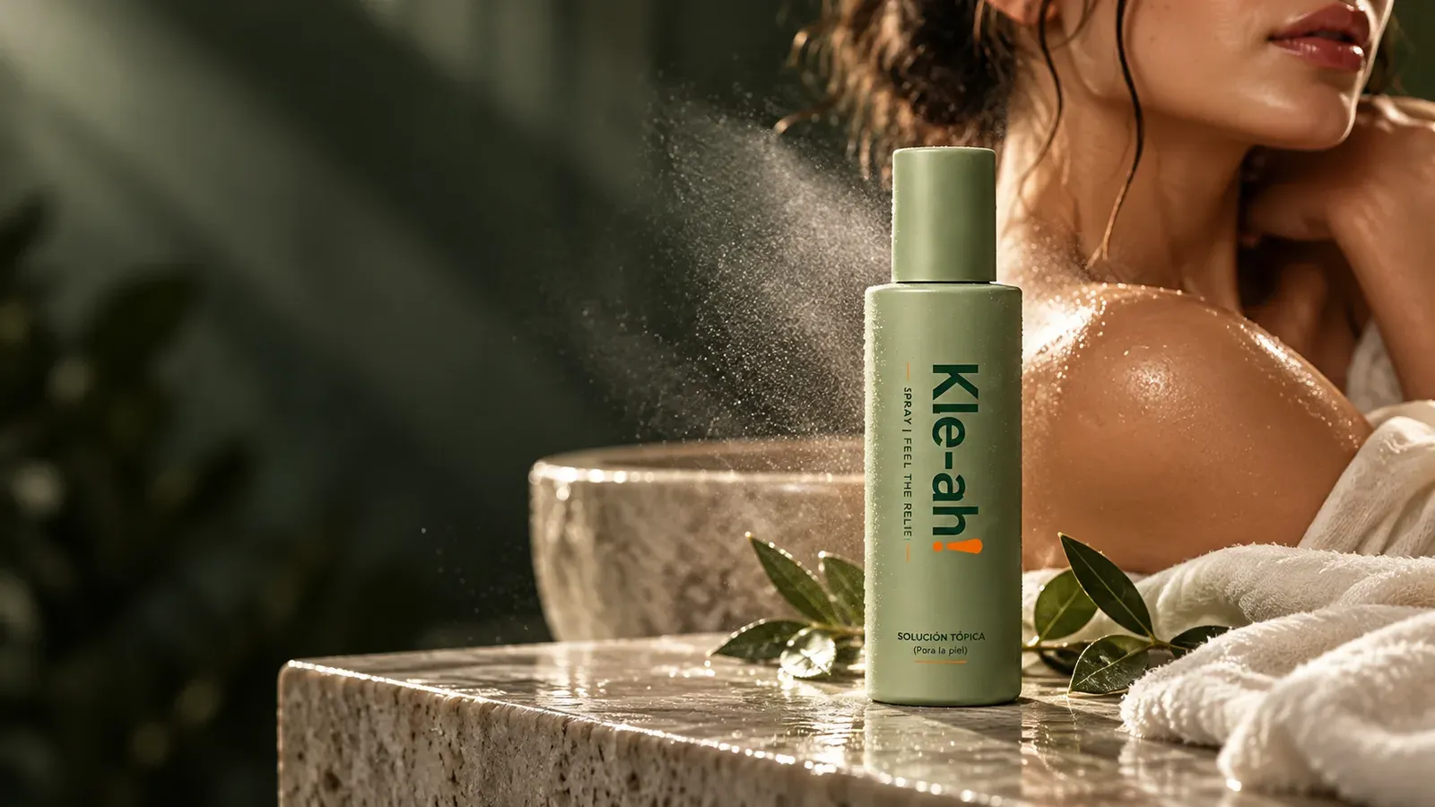 Kle-ah! skincare spray in a skin care setting Kle-ah! HOCl skin spray bottle on a stone ledge beside a soft mist of spray